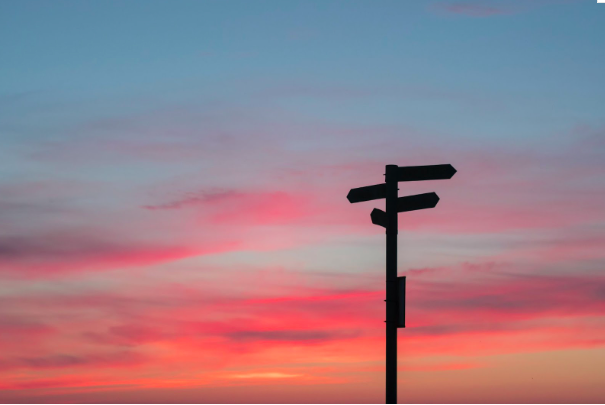 Picture of sunset with arrow signs.